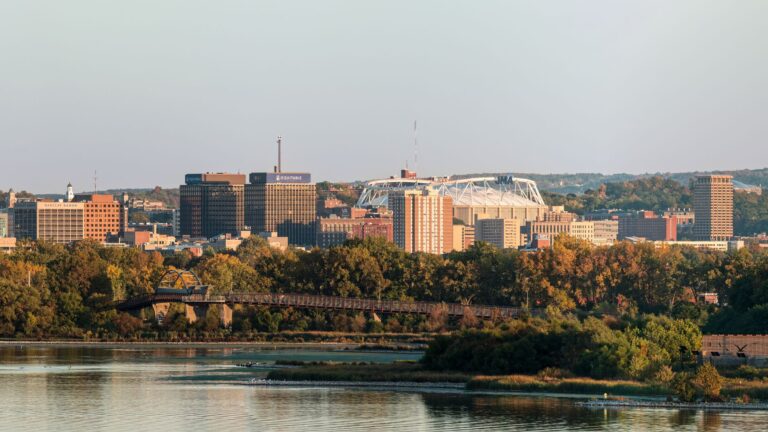 Panoramic view of Syracuse, New York skyline above Onondaga Lake during fall.