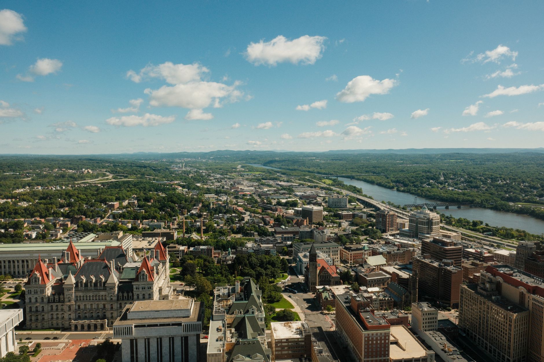 Stunning aerial shot of Albany cityscape and Hudson River on a clear day.